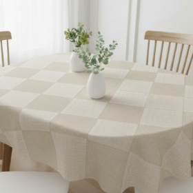 A beige linen Oval Tablecloth draped over a modern 6-seater dining table in a brightly lit kitchen.